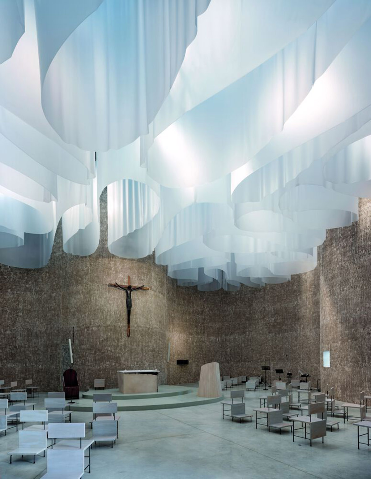 Smooth all-white walls form church designed by Mario Cucinella Architects in Mormanno hill town 