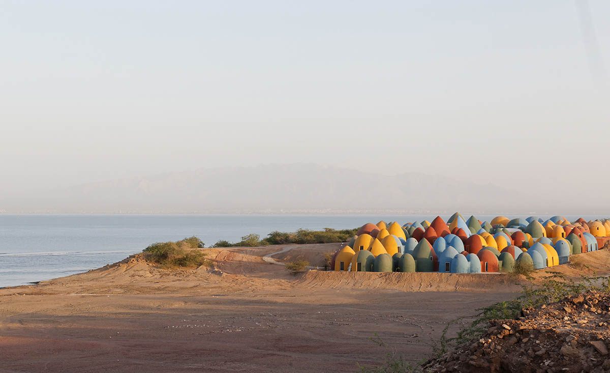 ZAV Architects built colorful-domed housing made of rammed earth and sand on Hormuz island, Iran