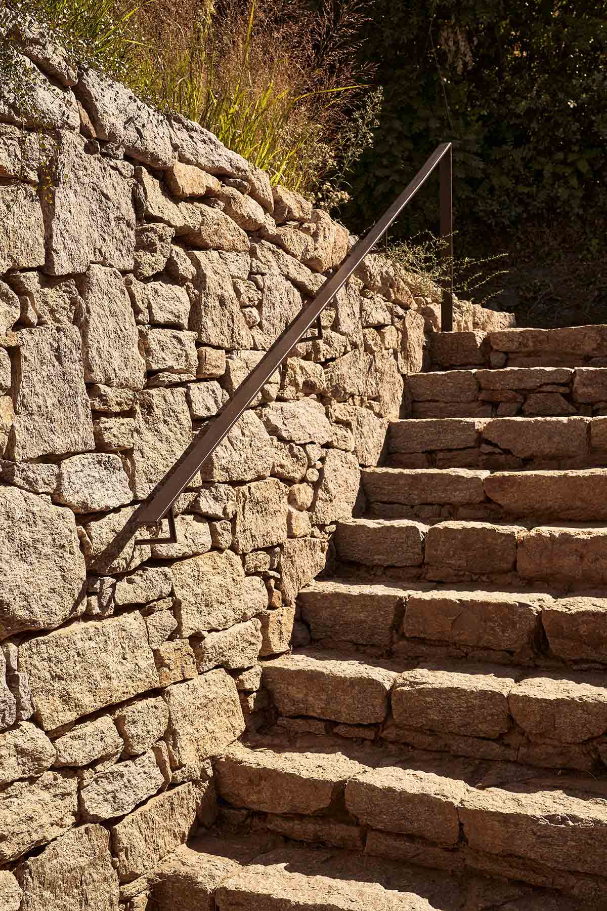 Terraced stonewalls sprawl down to offer an exploratory route in an old vineyard in Samos