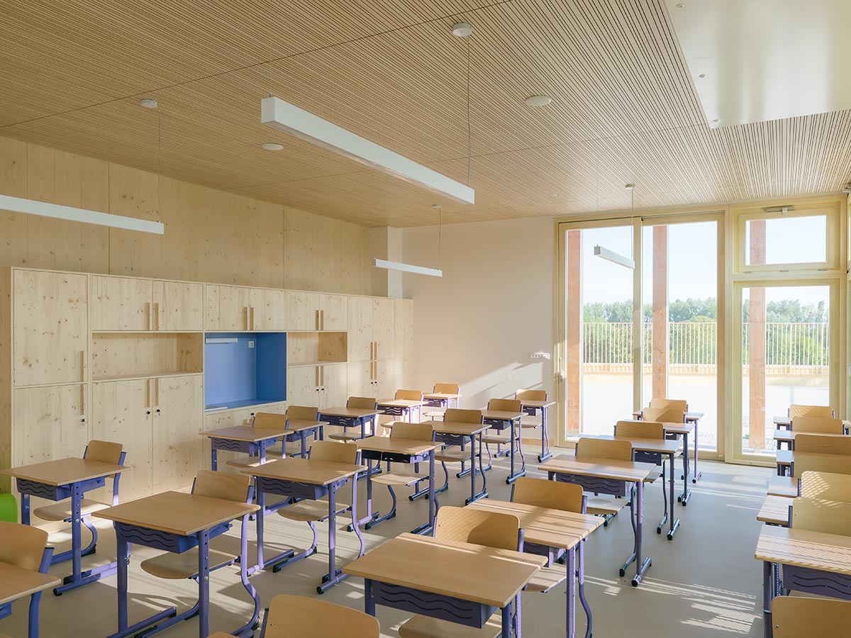 Wooden school by r2k architecte is inspired by Nordic architecture to be a positive energy building