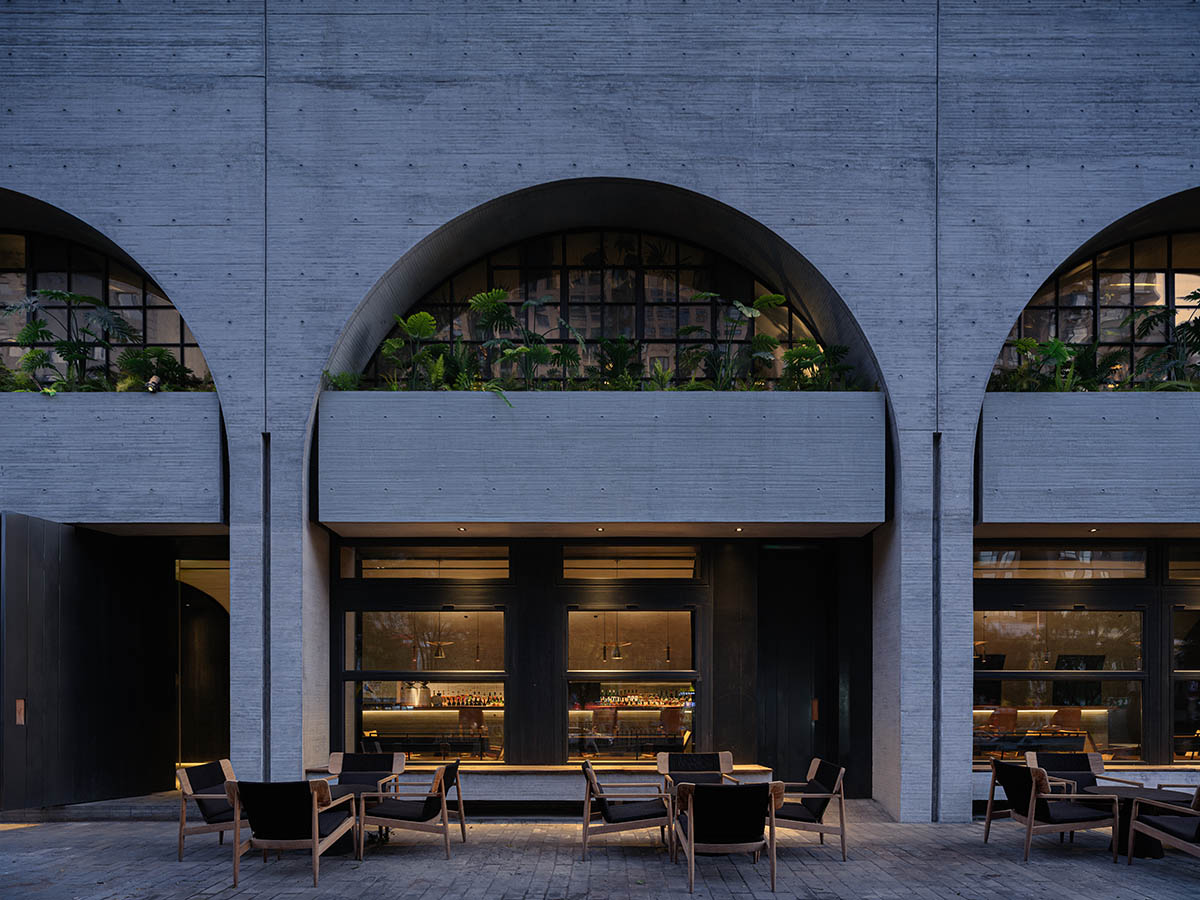 Large triple-arched windows enhance the iconic presence of the concrete Whisky Bar in Taiyuan, China
