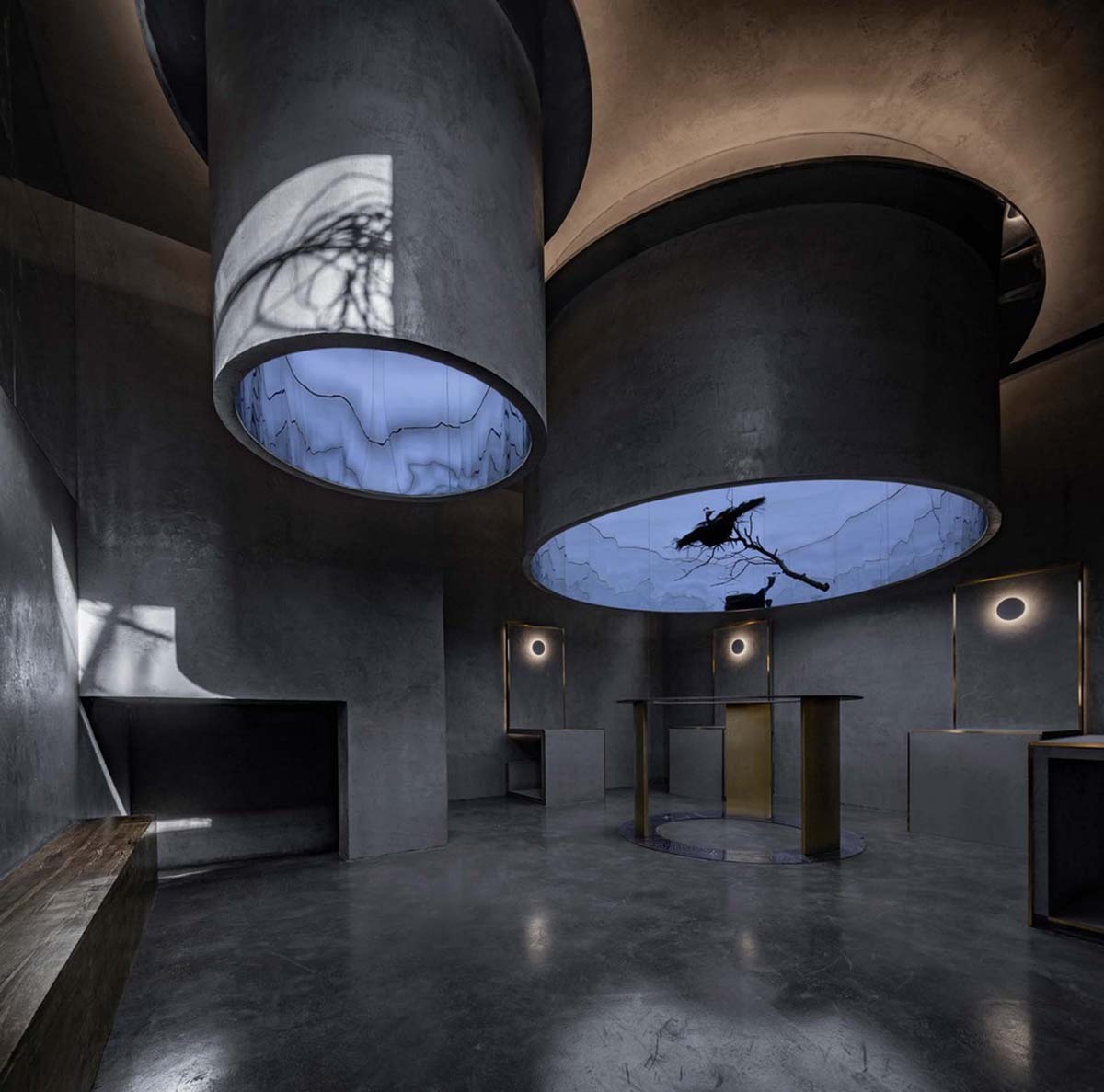 Linkchance Architects creates coffee store and art studio with golden metallic interiors in Beijing