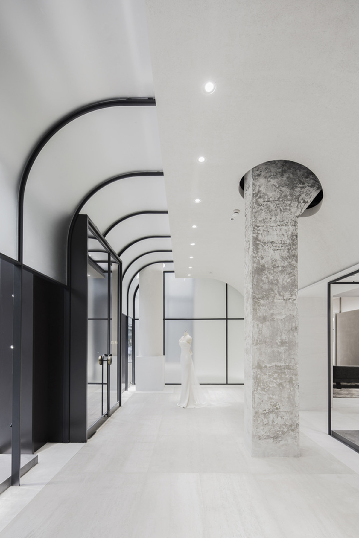 Atelier tao+c combines bright interior with black-framed showcase rooms for flagship store in China