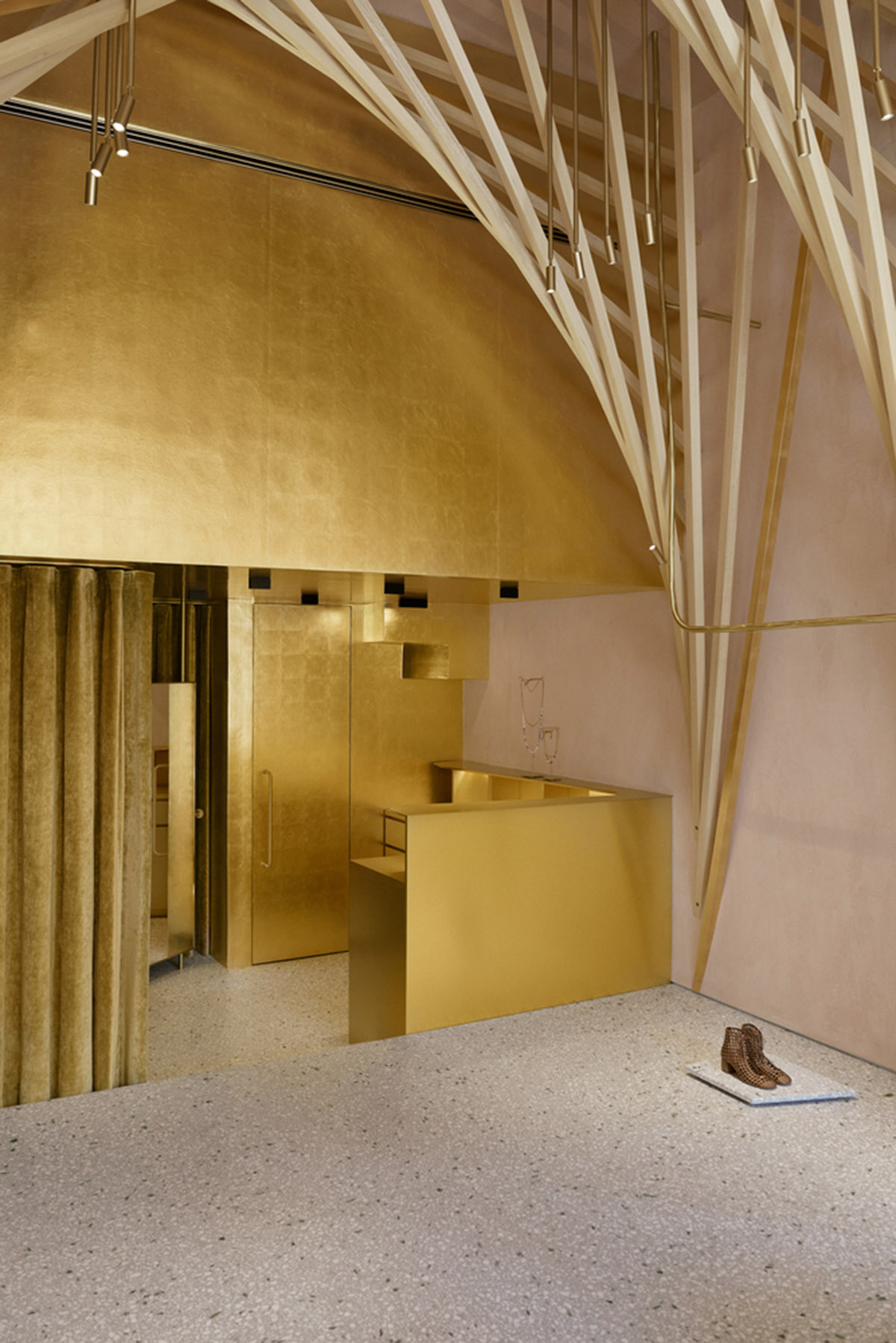 Golden and powder-colored details dominate forte_forte forte dei Marmi boutique in Italy