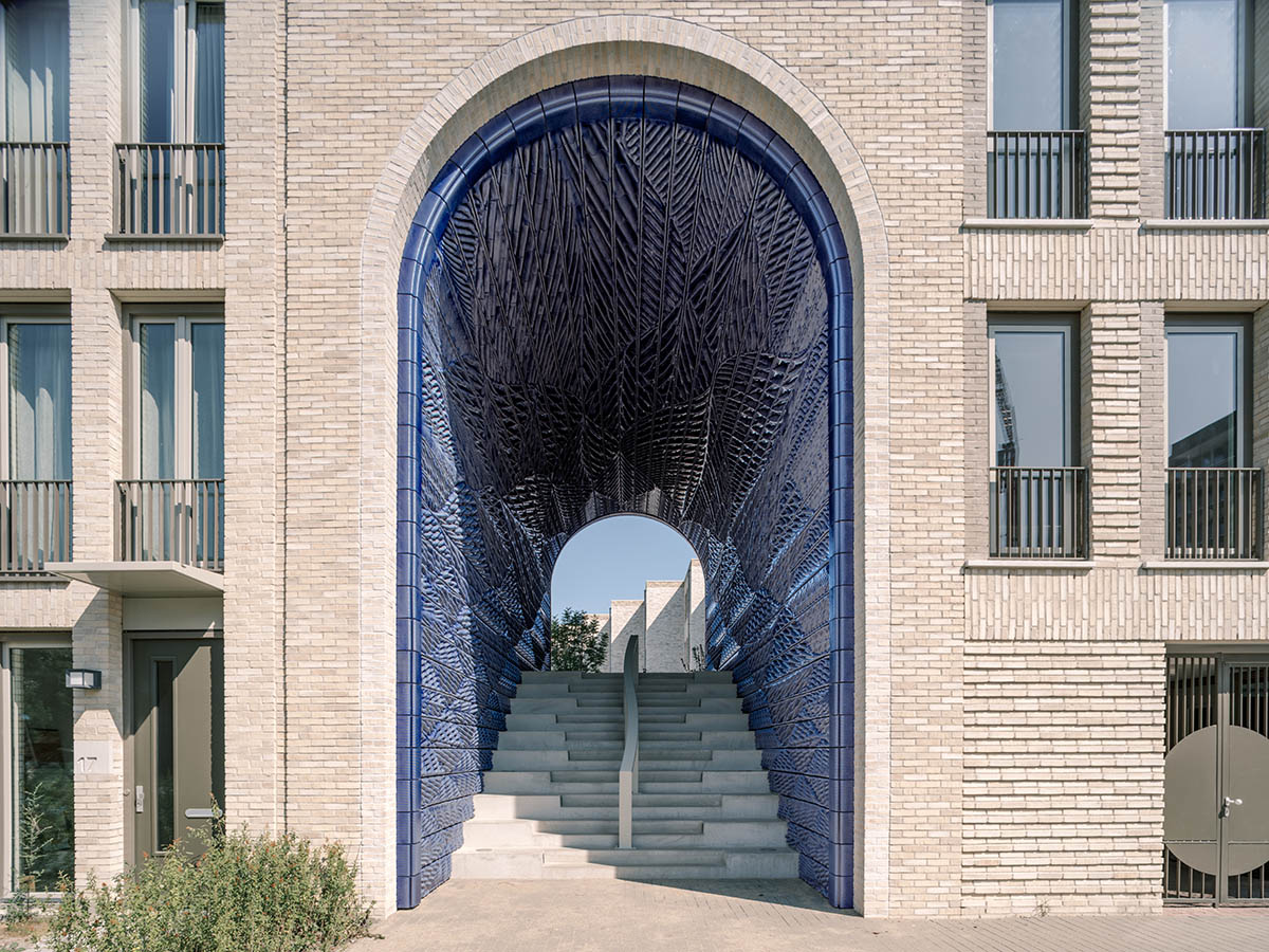 Studio RAP clads two gates of PoortMeesters residential building block in 3D blue porcelain
