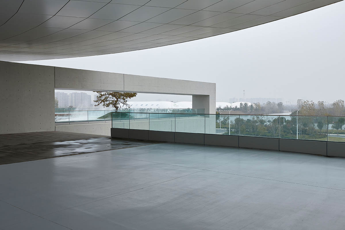 STUDIO A+ designs climbable ring-shaped art center on a green mound in Zhengzhou