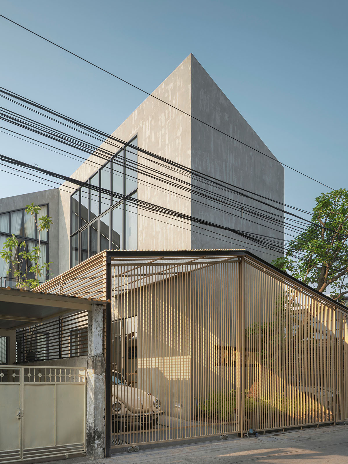 AUN Design Studio adds steel fence to private home for airy entrance in Bangkok