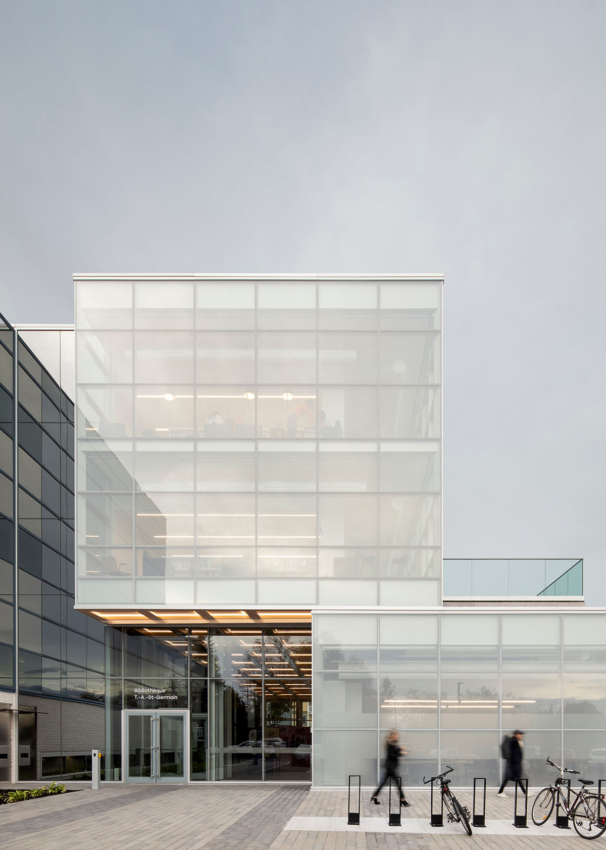 Whitish glass library designed by ACDF Architecture acts as a white floating volume in Quebec