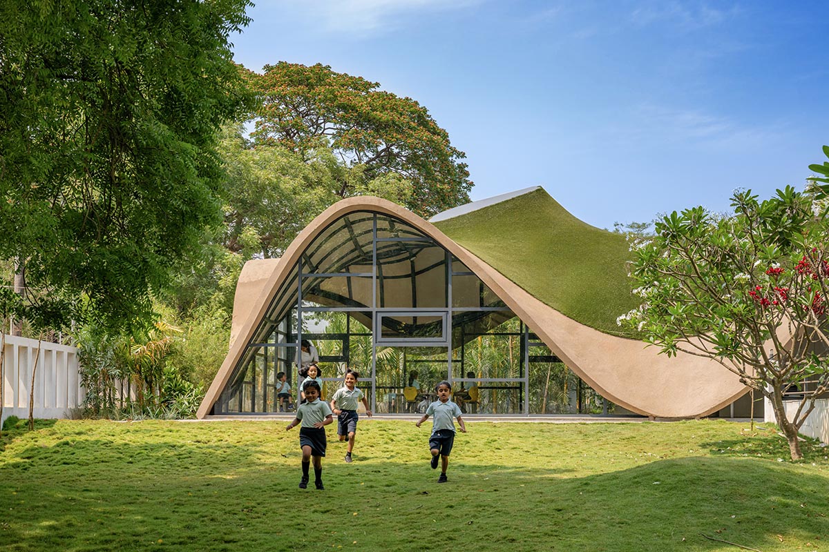 Undulating roof covers Cocoon School for unobstructed space in India 