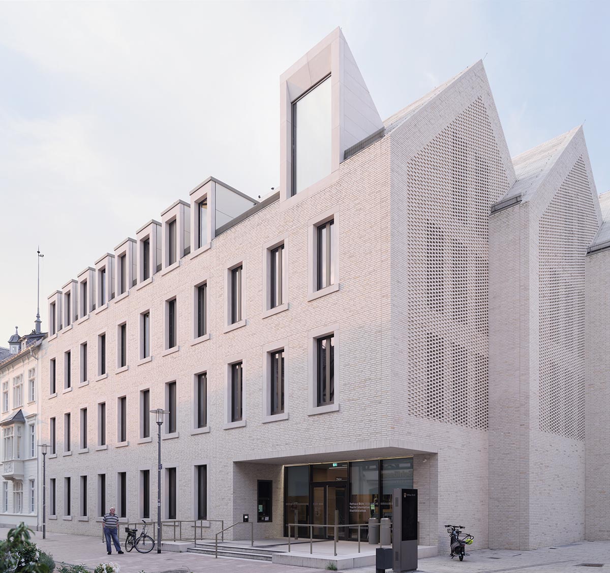 JSWD extends 1960s town hall with interlocking structures and perforated façade in Germany 