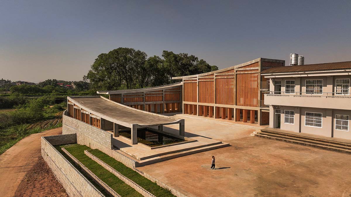 Staggered volumes define educational and cultural centre shaped around the pond in China