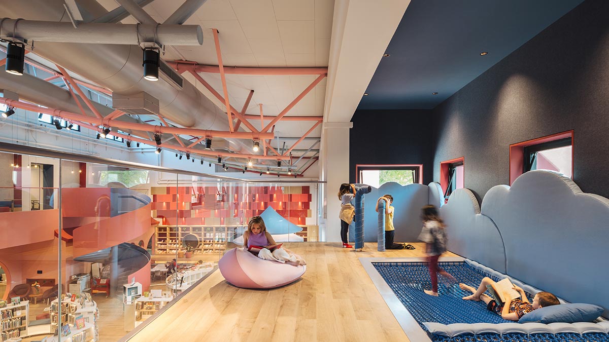 Elementary school library features vibrant colors and playful elements, resembling a fairy tale 