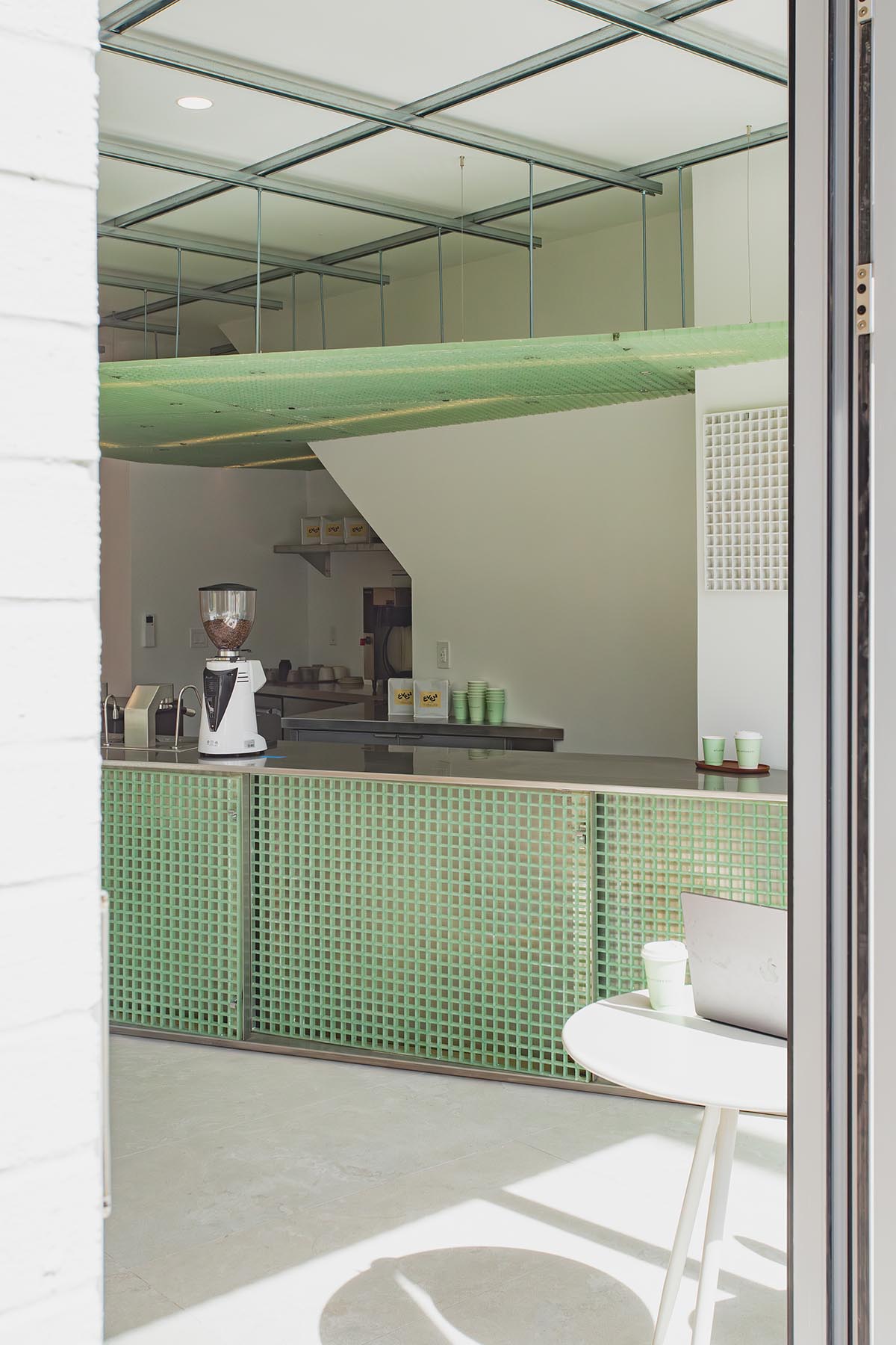 Misc Coffee makes a bold statement with green translucent bar in a busy street of Toronto