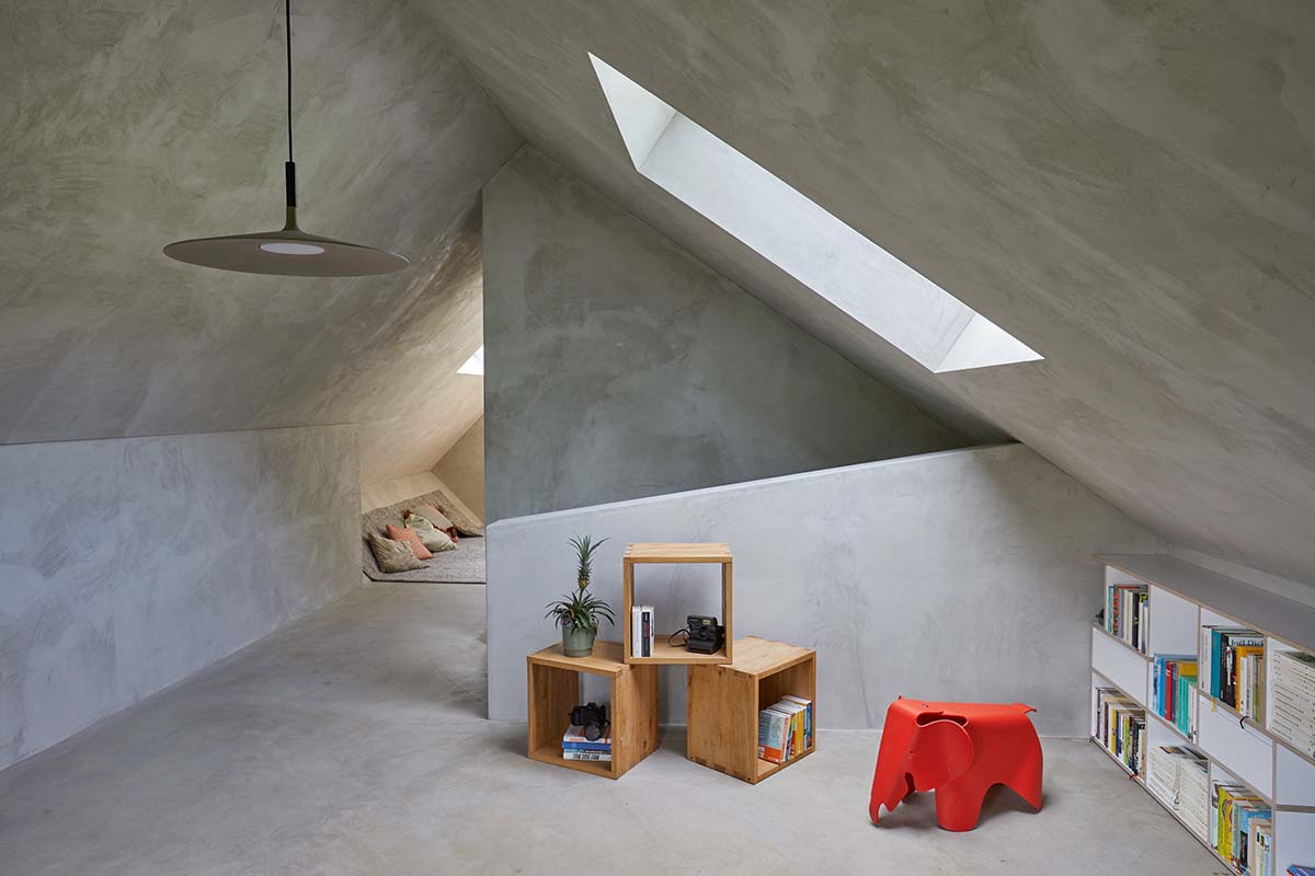 Residential barn features an unfinished, raw interior in Swiss rural landscape