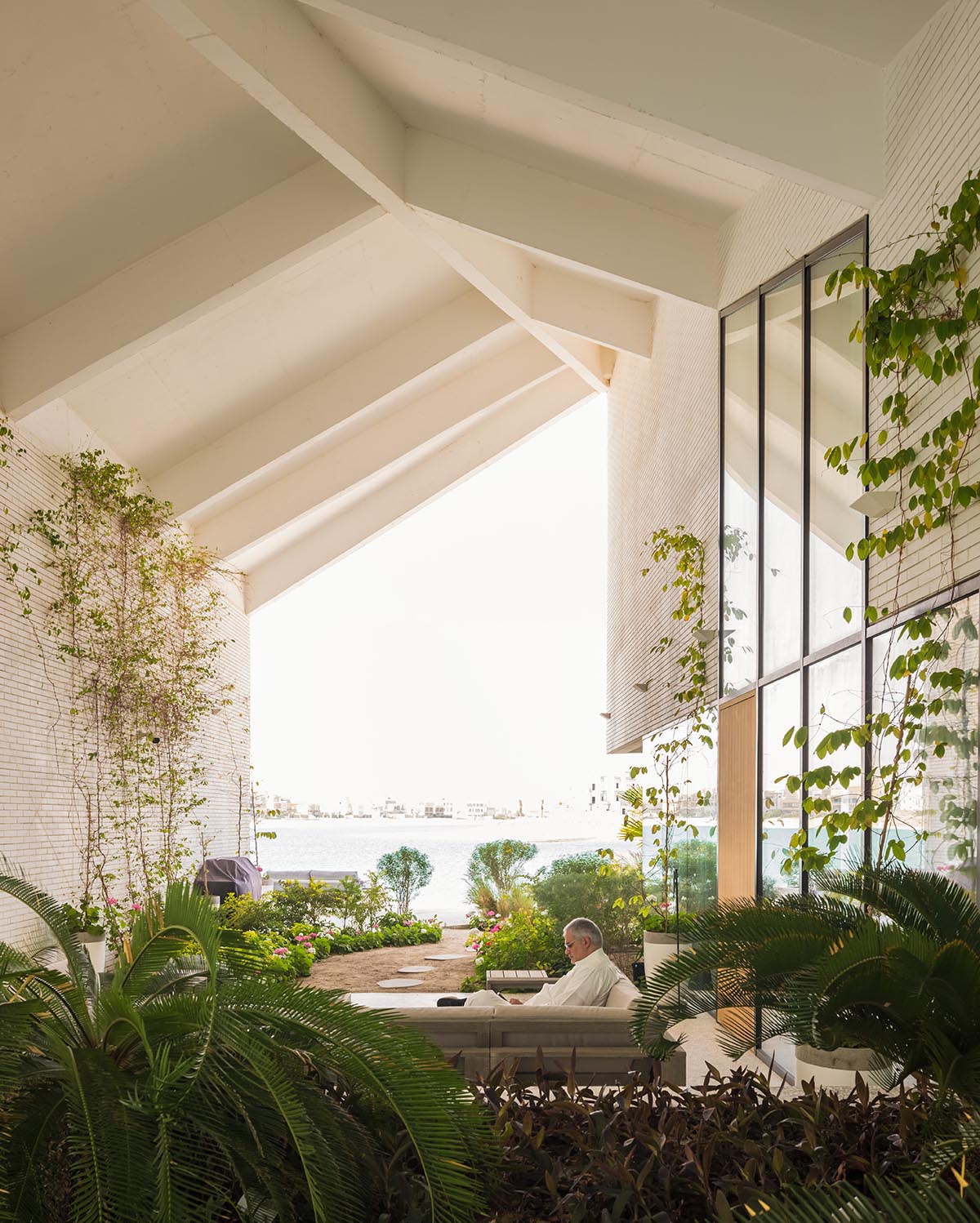 Family house is covered by folded roof to create a tent-like structure on Kuwait's seaside 