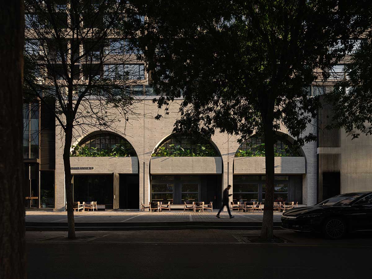 Large triple-arched windows enhance the iconic presence of the concrete Whisky Bar in Taiyuan, China