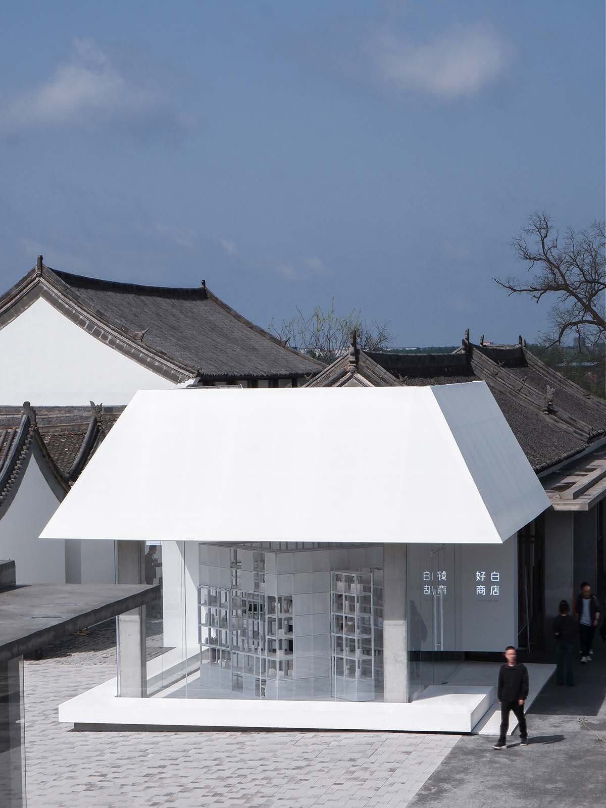 A shop is attached to Beijing historic Hutong houses with white-colored skin