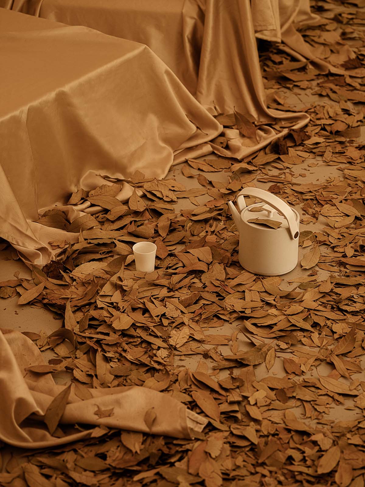 Tea house interiors wrapped by earth-toned fabric curtains act like 