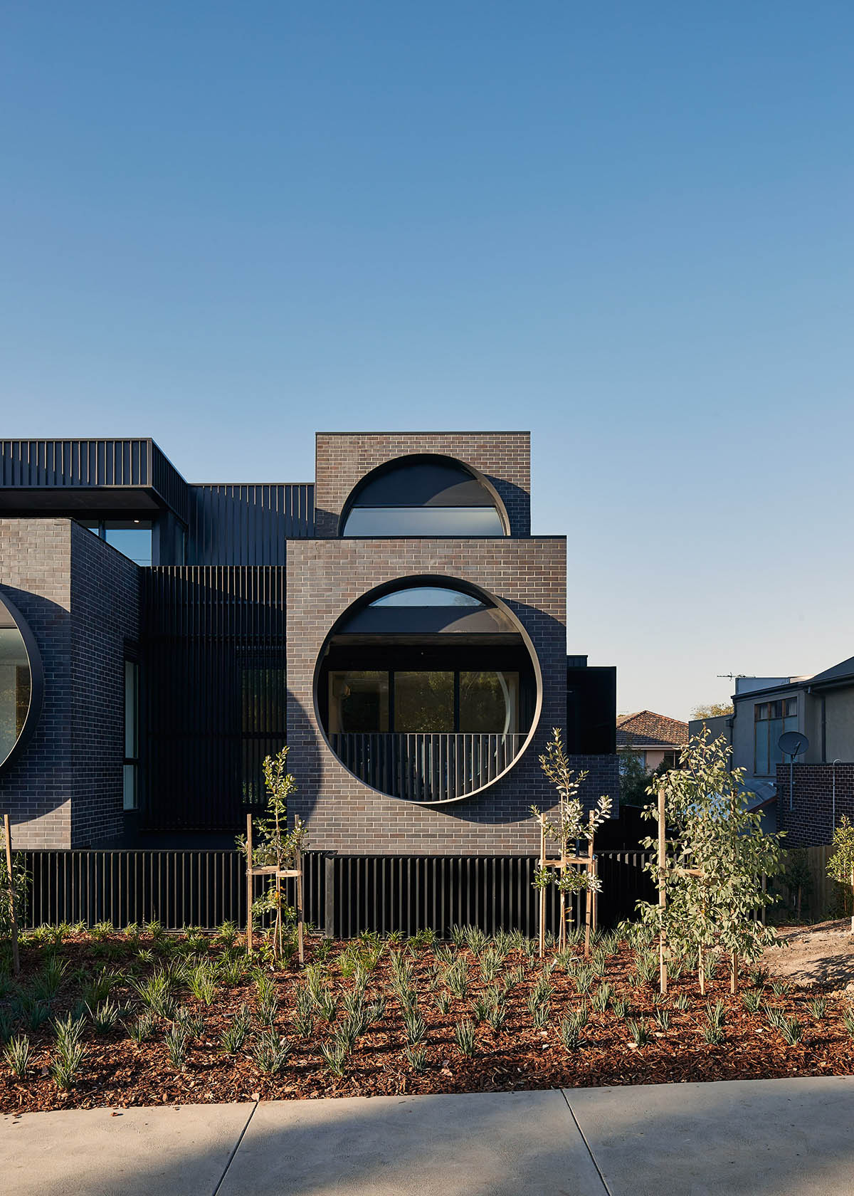 Oversized circular windows dominate the facade of Cirqua Apartments in Melbourne
