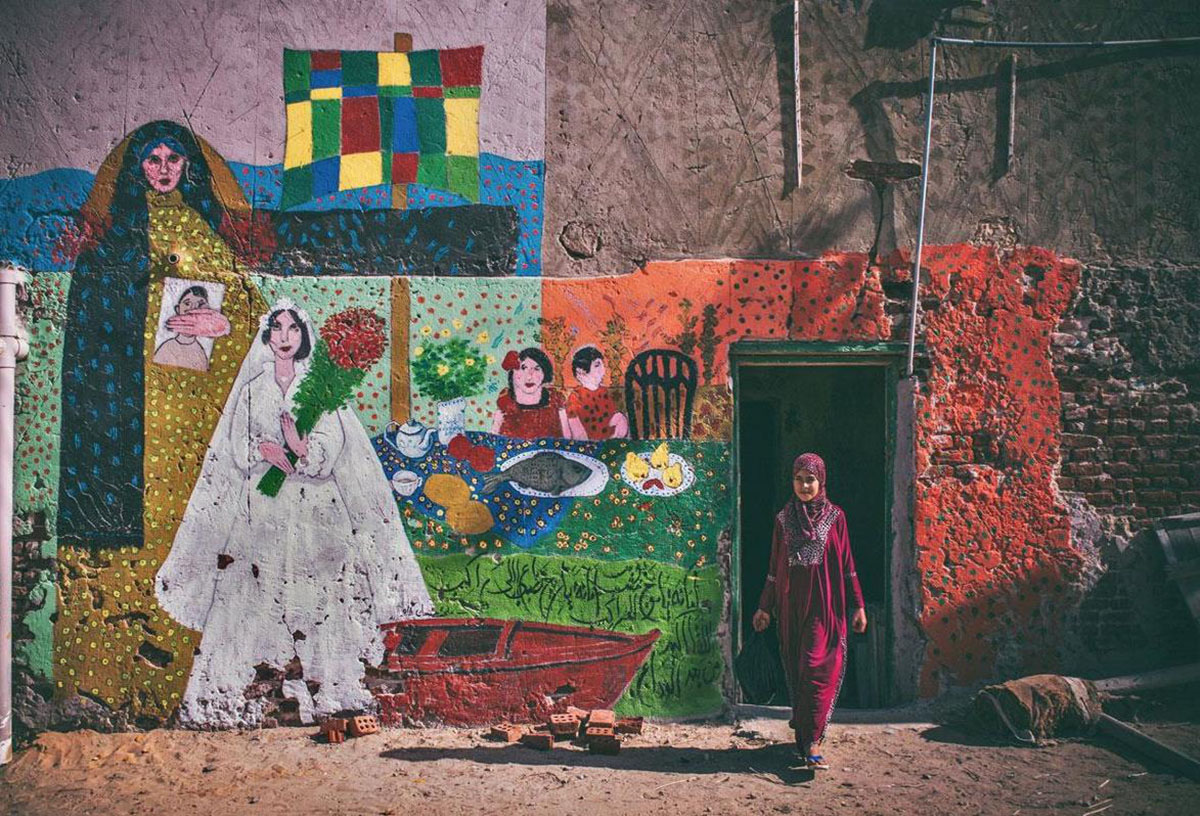 Mona Hassan captures Egyptian Village Festival Houses composed of colourful paintings by 40 artists