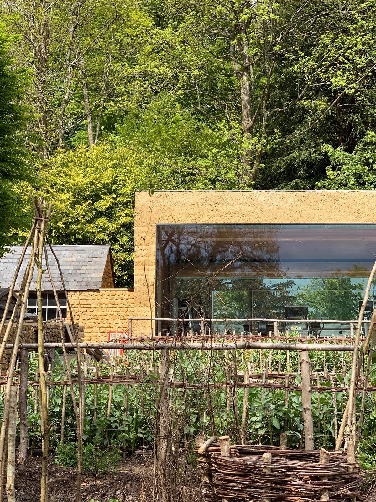 Invisible Studio creates large window for a gymnasium overlooking to a productive garden in Somerset