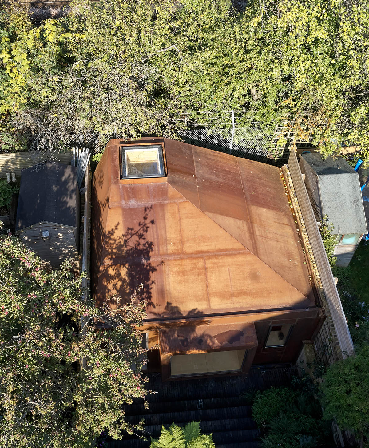 RISE Design Studio built sunken garden studio with rusted steel to provide a hidden place to escape