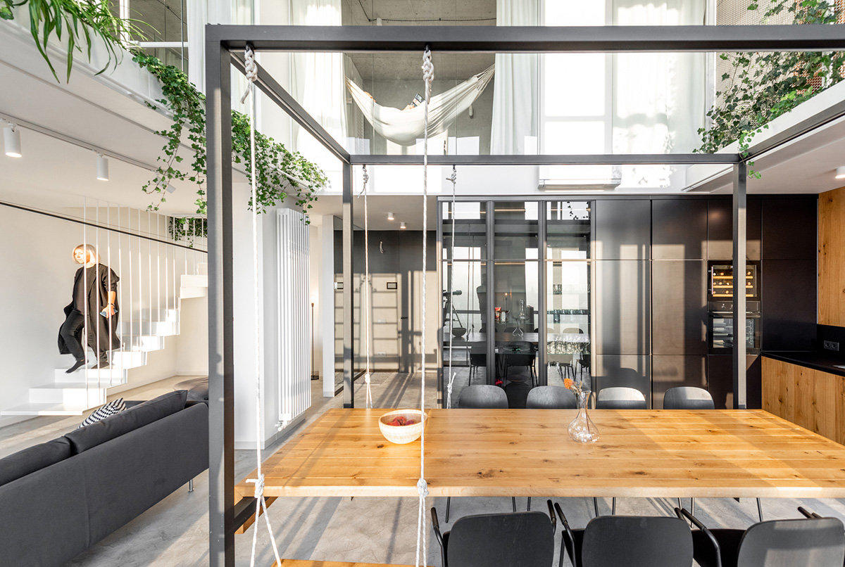 Metal framed-table, glass partitions, green infills make this interior space vivid and light in Lviv