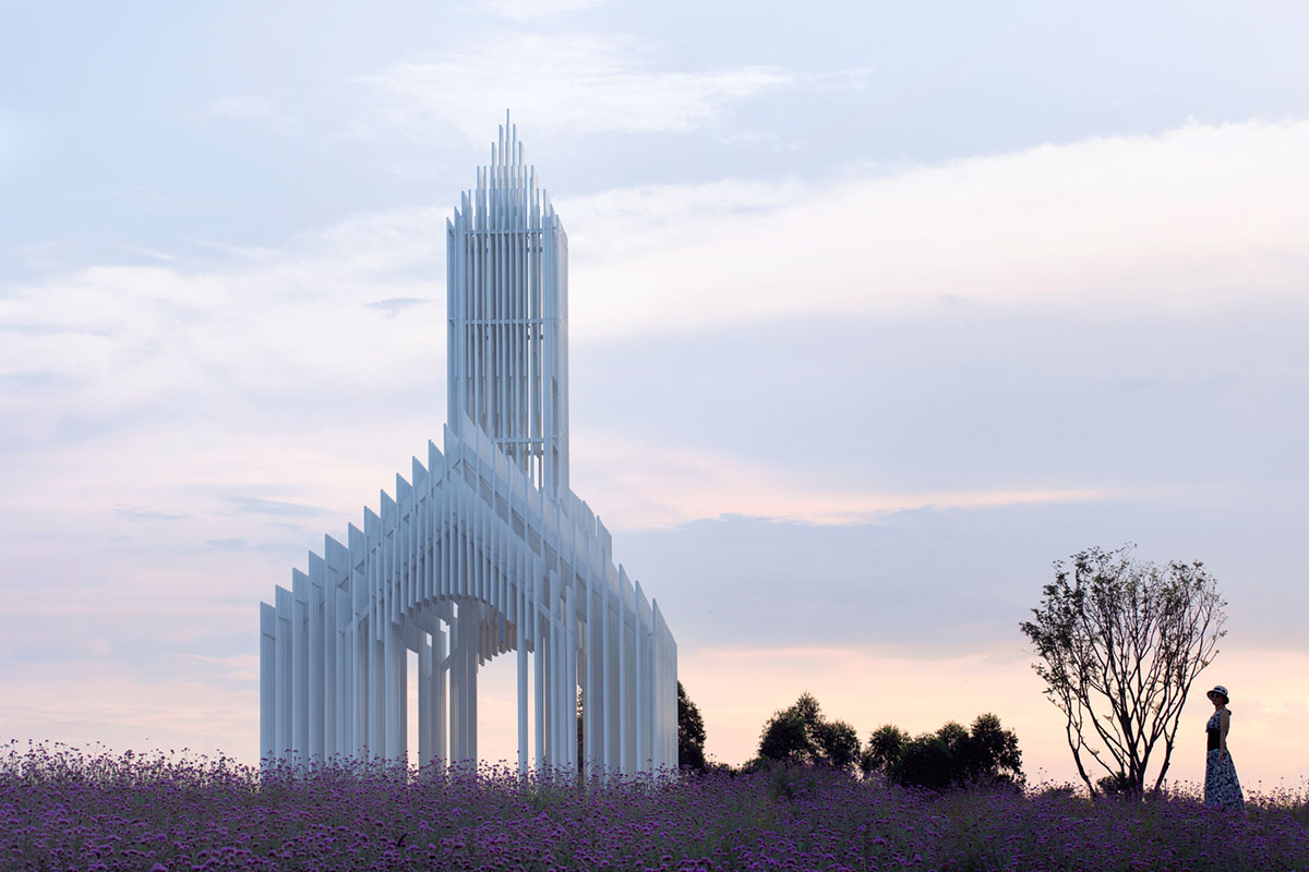 A church made of thousands of white thin beams looks like suspended in the air in lavender field