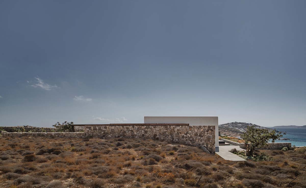 K Studio built small holiday villa with round-edged volumes and shading elements in Mykonos