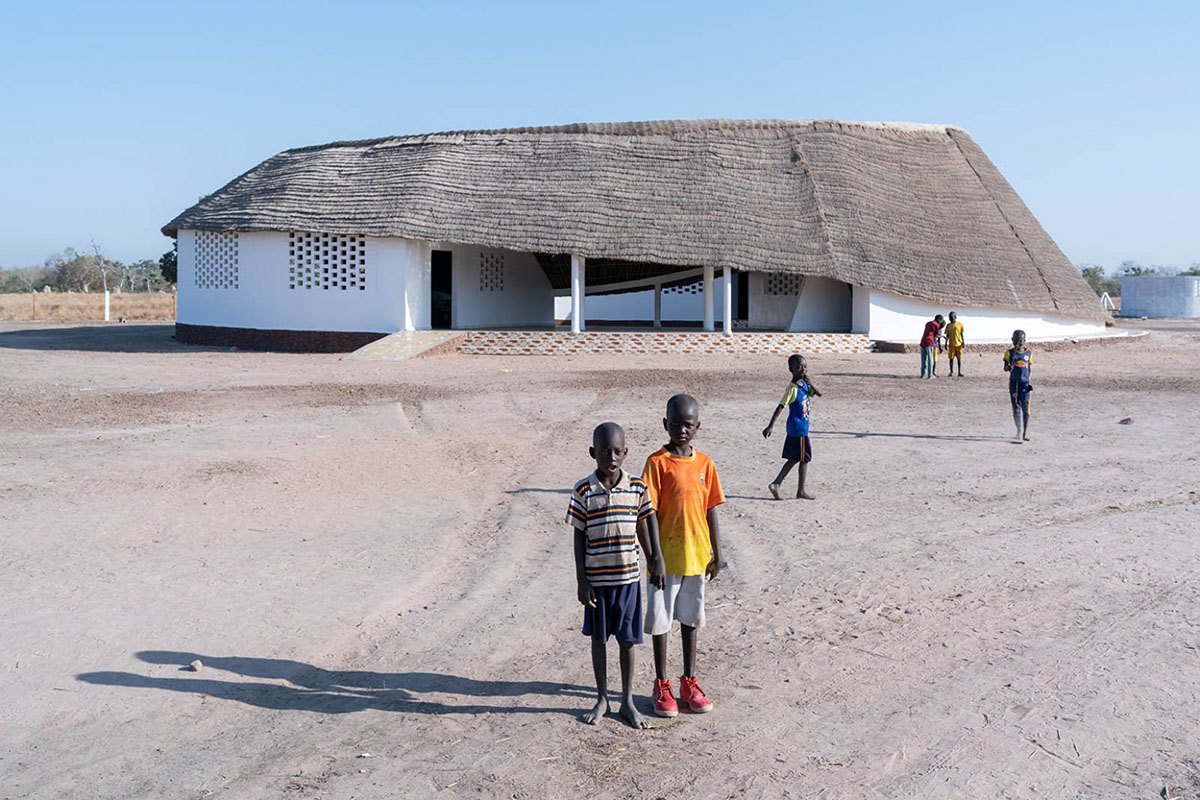 Toshiko Mori built Fass School and Teachers’ Residence featuring wavy thatched roof in remote Senegal