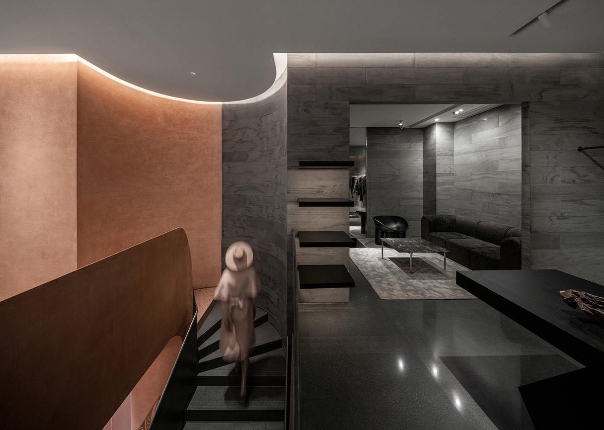 Pink elements and dark colors create sharp contrast in the interiors of restaurant and showroom