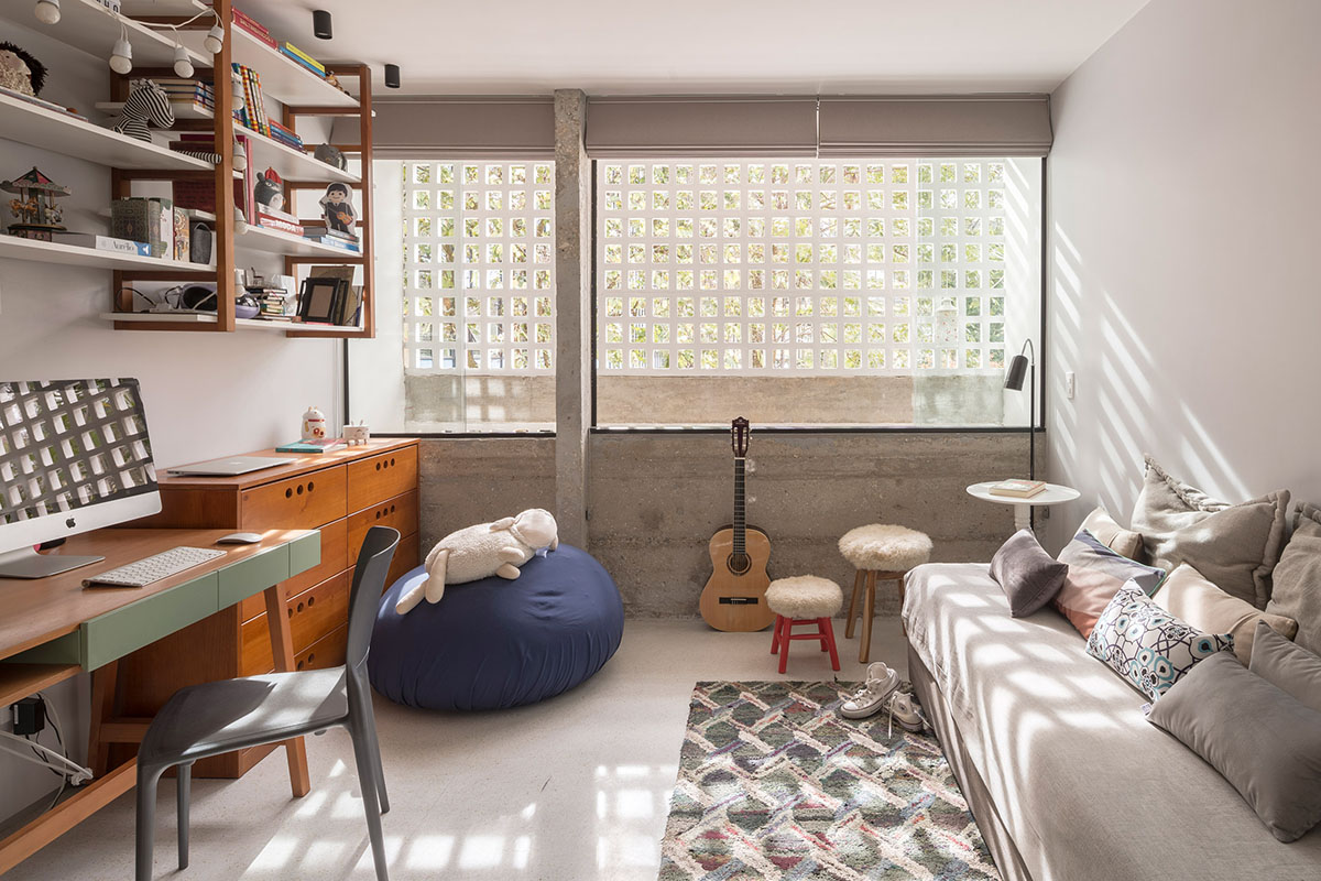 A historic Brazilian apartment has been redesigned with wooden bookcase as main divider