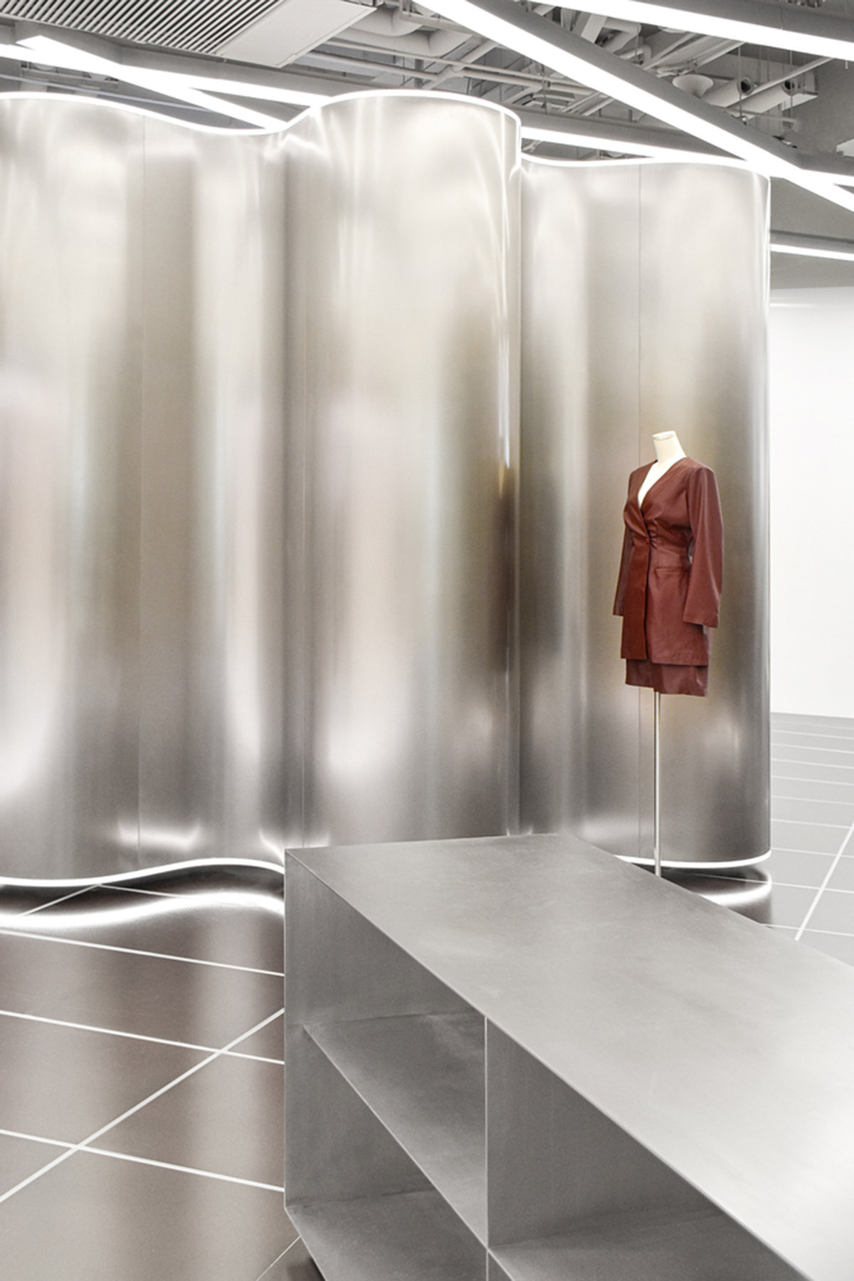 RAMOPRIMO uses steel curved walls to highlight garments in the interior of fashion store in China