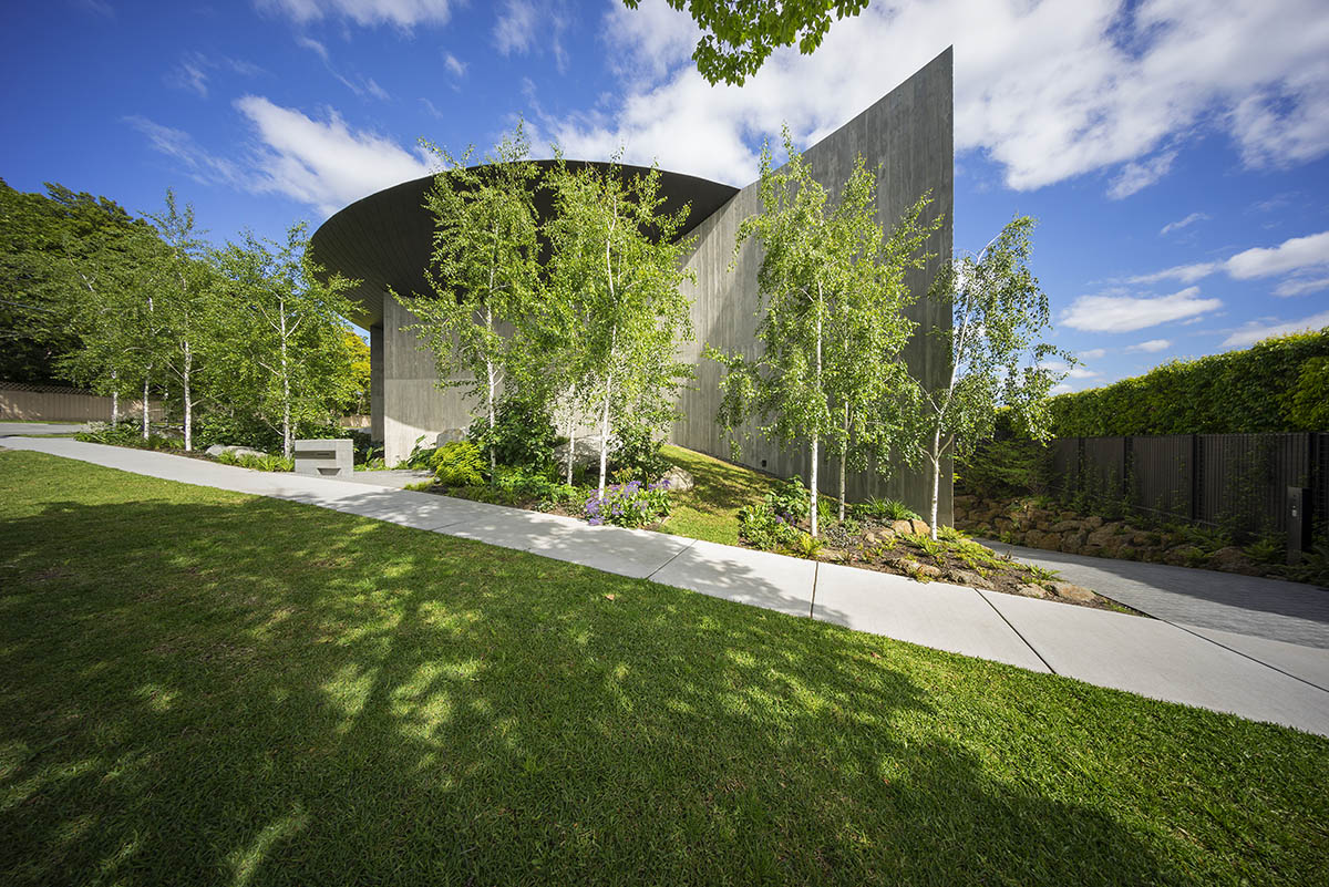 Wood Marsh built sculptural Towers Road House that features disc-shaped zinc roof in Toorak