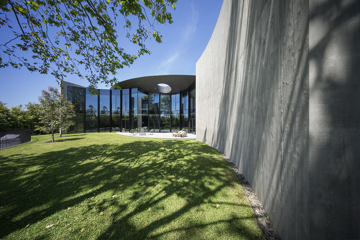 Wood Marsh built sculptural Towers Road House that features disc-shaped zinc roof in Toorak