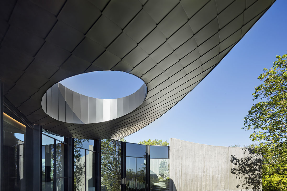 Wood Marsh built sculptural Towers Road House that features disc-shaped zinc roof in Toorak