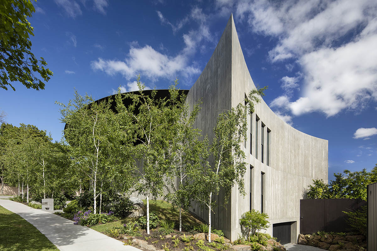 Wood Marsh built sculptural Towers Road House that features disc-shaped zinc roof in Toorak