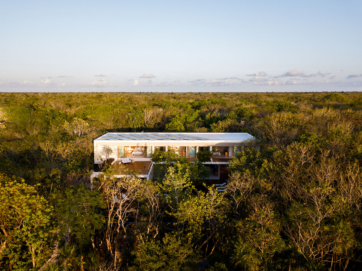 Sordo Madaleno Arquitectos' L-shaped residence disappears in a lush vegetation of Mexican island