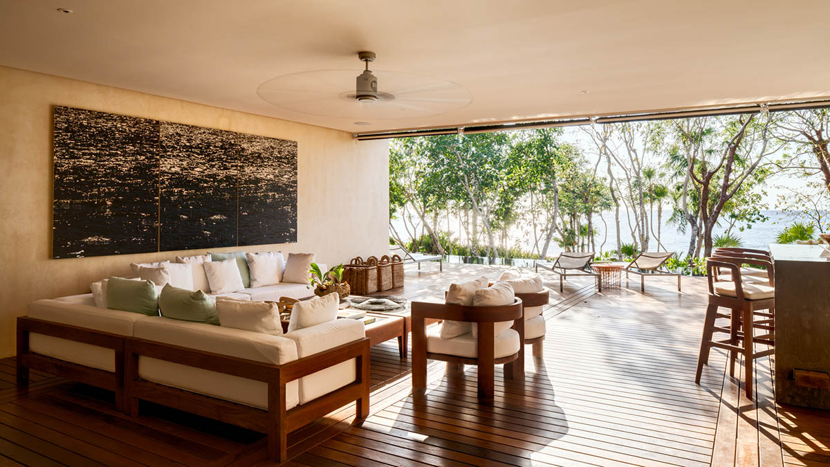 Sordo Madaleno Arquitectos' L-shaped residence disappears in a lush vegetation of Mexican island