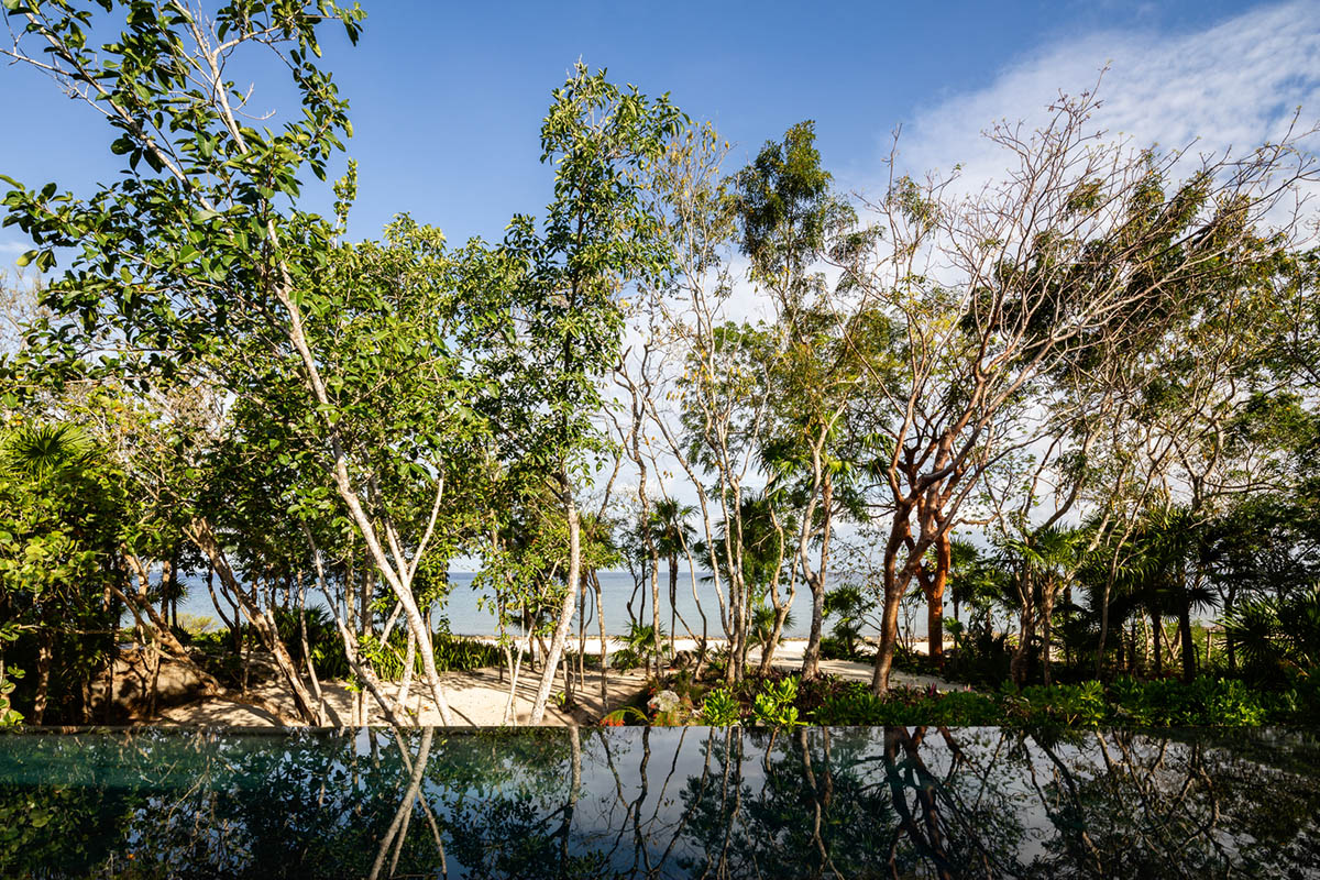 Sordo Madaleno Arquitectos' L-shaped residence disappears in a lush vegetation of Mexican island