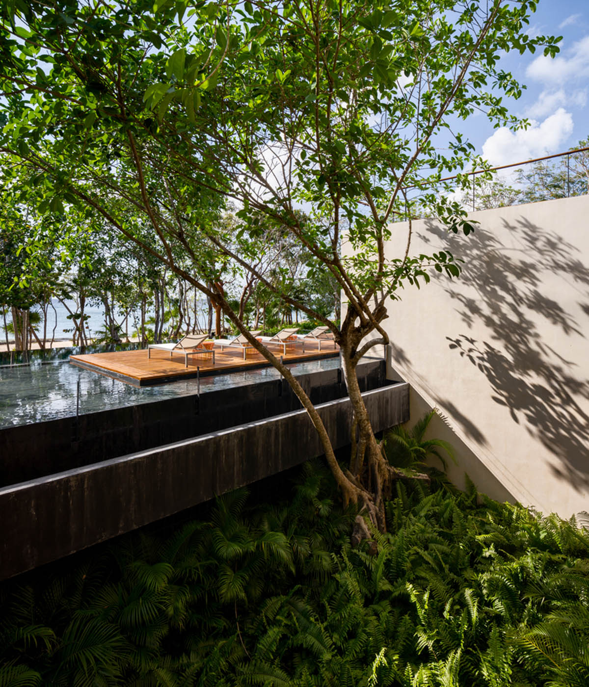 Sordo Madaleno Arquitectos' L-shaped residence disappears in a lush vegetation of Mexican island