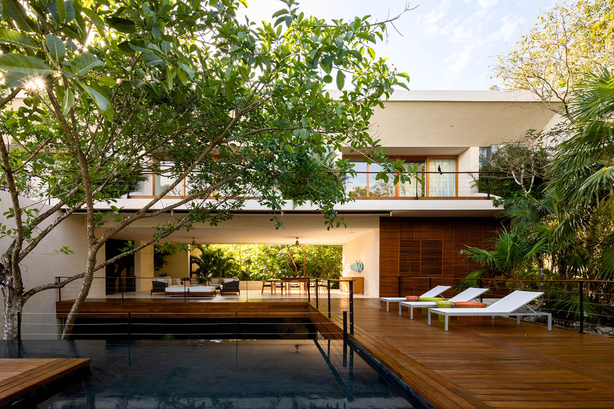 Sordo Madaleno Arquitectos' L-shaped residence disappears in a lush vegetation of Mexican island