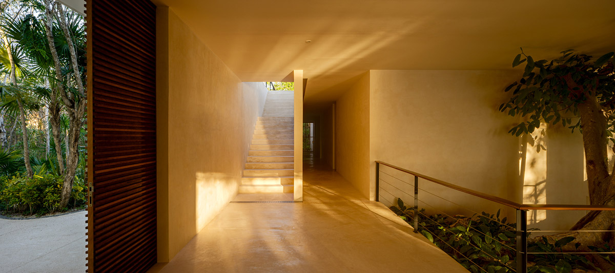 Sordo Madaleno Arquitectos' L-shaped residence disappears in a lush vegetation of Mexican island
