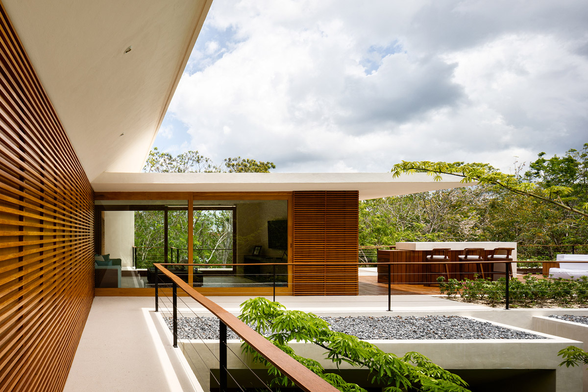 Sordo Madaleno Arquitectos' L-shaped residence disappears in a lush vegetation of Mexican island