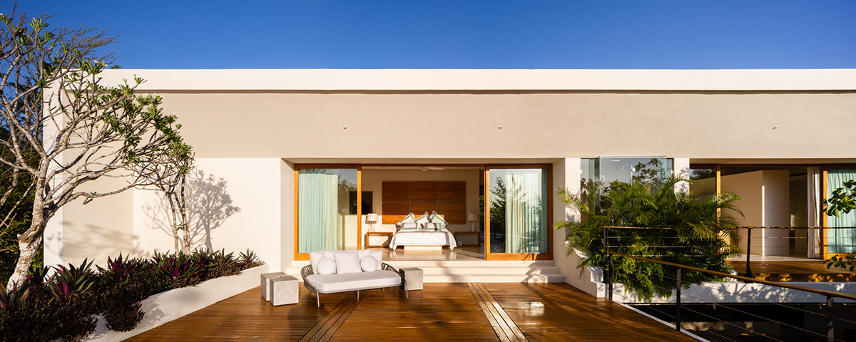 Sordo Madaleno Arquitectos' L-shaped residence disappears in a lush vegetation of Mexican island