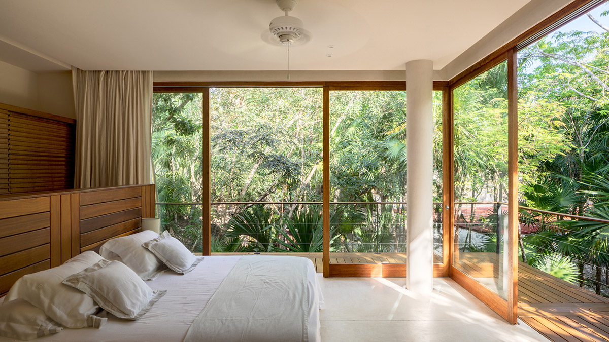 Sordo Madaleno Arquitectos' L-shaped residence disappears in a lush vegetation of Mexican island