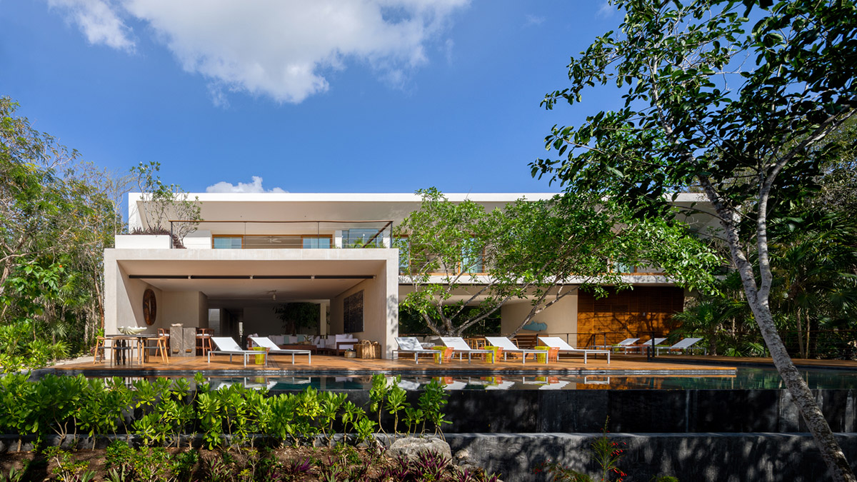 Sordo Madaleno Arquitectos' L-shaped residence disappears in a lush vegetation of Mexican island