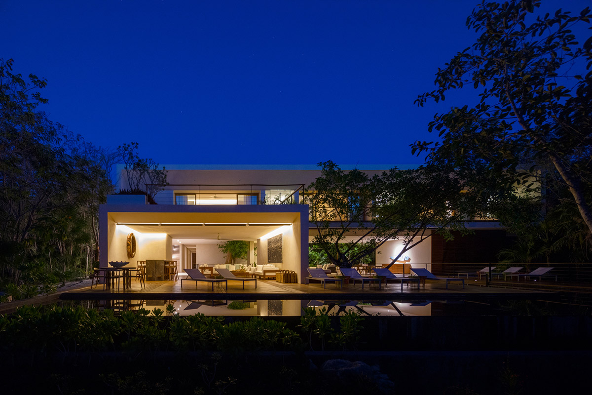 Sordo Madaleno Arquitectos' L-shaped residence disappears in a lush vegetation of Mexican island