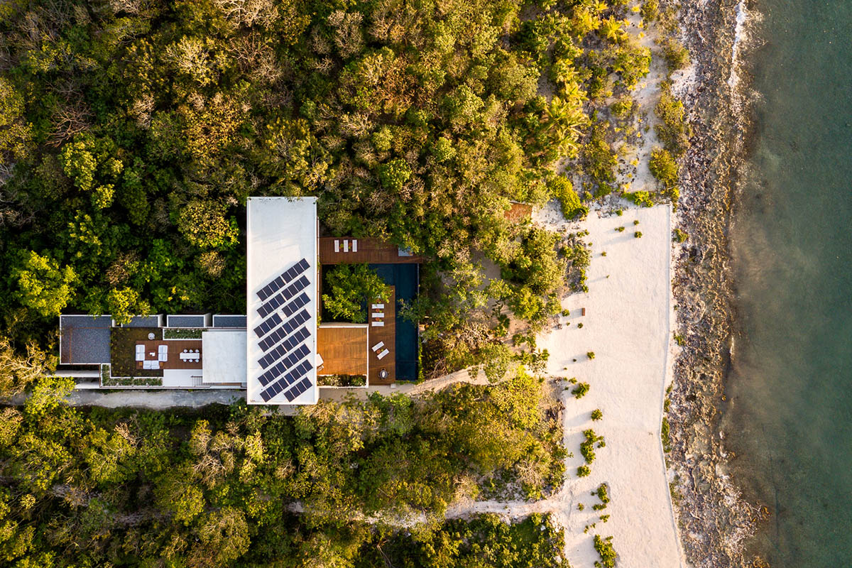 Sordo Madaleno Arquitectos' L-shaped residence disappears in a lush vegetation of Mexican island