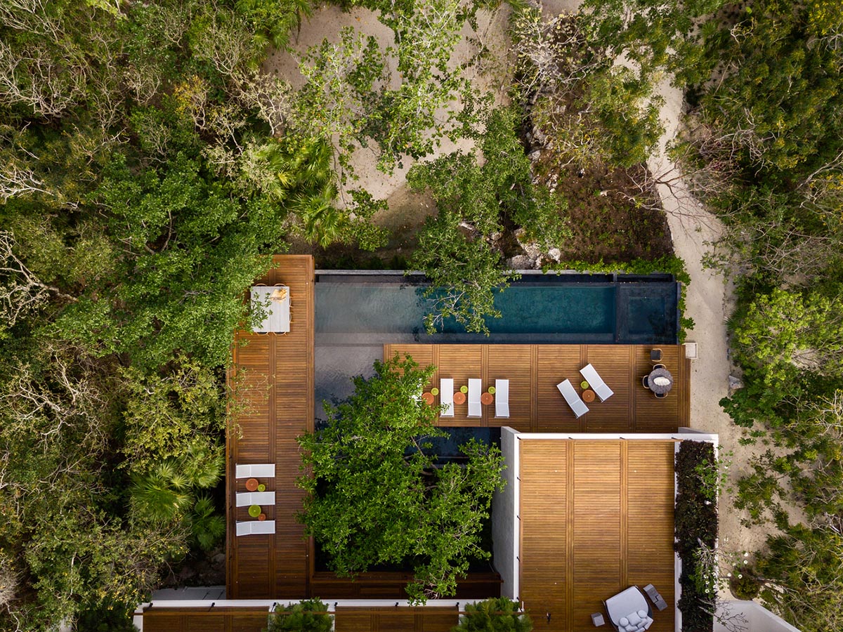 Sordo Madaleno Arquitectos' L-shaped residence disappears in a lush vegetation of Mexican island